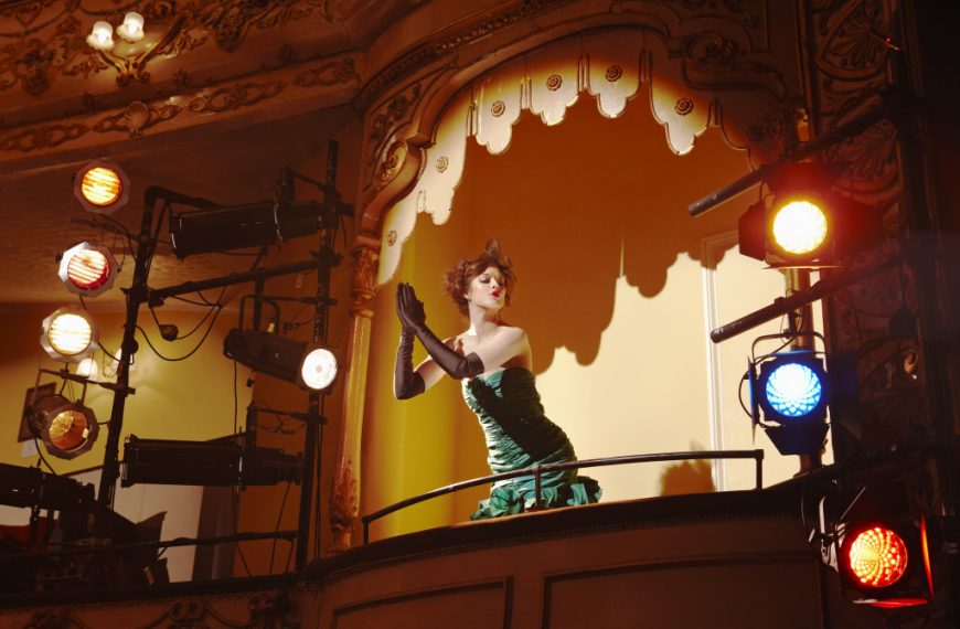 Low angle view of a beautiful young woman in theatre box