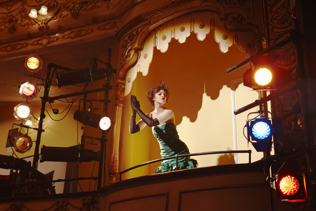 Low angle view of a beautiful young woman in theatre box