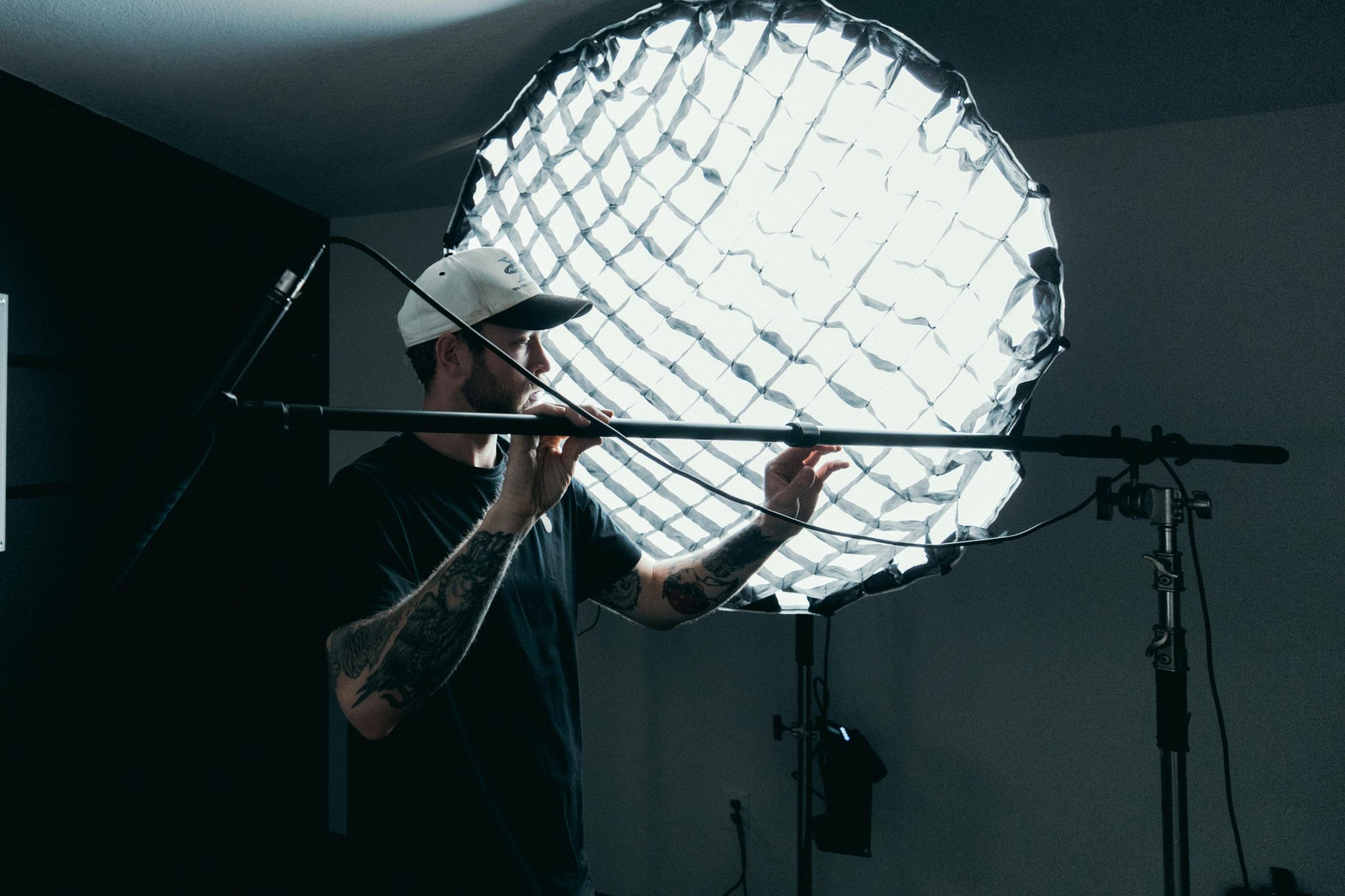 director with a large film light in the background