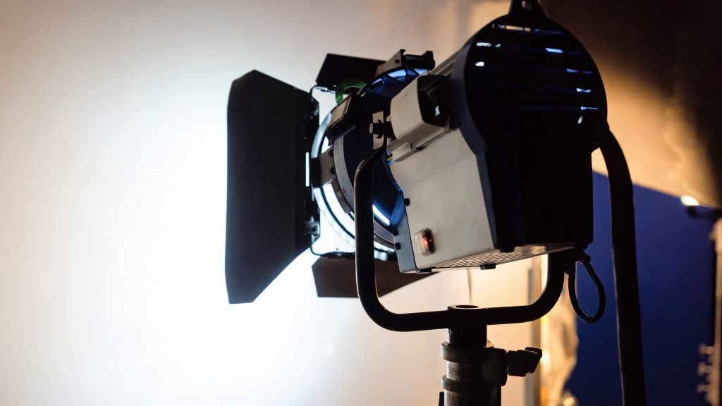 professional film lighting equipment set up on a movie set, creating high key lighting