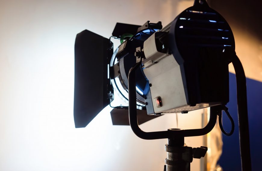 professional film lighting equipment set up on a movie set, creating high key lighting